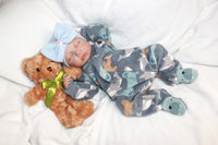Thumbnail for A baby adorned with a bow, gently holding a teddy bear, radiating innocence and joy.