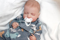 Thumbnail for A peaceful baby sleeps soundly, a pacifier gently resting in its mouth, embodying tranquility and innocence.