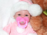 Thumbnail for A baby doll with a pacifier rests on a soft blanket, showcasing its cute features and gentle expression.