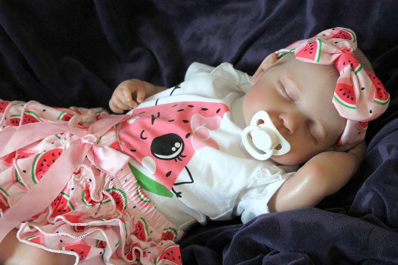 Reborn doll in watermelon outfit that says summer. Lifelike Reborn Baby Doll 20” 2 to 8 Pounds Weighted Newborn Baby Girl/Boy Soft Heavy Baby Dolls For Children Child Friendly Gifts For Girls