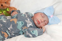 Thumbnail for A cute baby in a bow, cuddling a teddy bear, embodying warmth and playfulness.