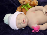 Thumbnail for Full Silicone Doll baby doll is positioned on a purple blanket, next to a teddy bear, illustrating a delightful and cozy atmosphere.