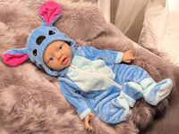 Thumbnail for A baby doll wearing a blue outfit, featuring a cute expression and soft, plush material.