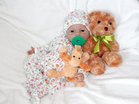 Thumbnail for A baby doll with a pacifier placed on its head, showcasing a playful and whimsical design.