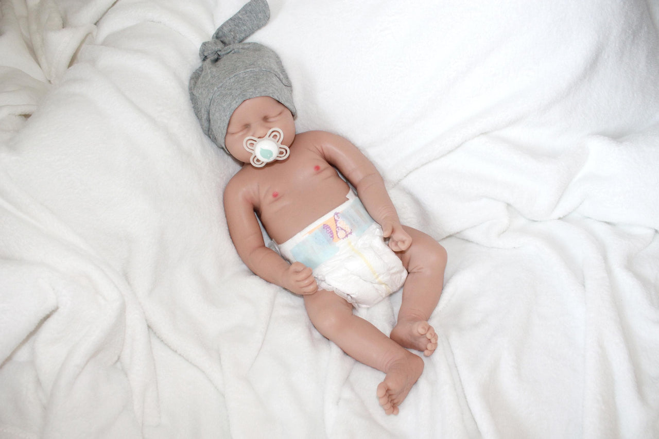 A baby doll wearing a diaper on its face, creating a whimsical and amusing visual.