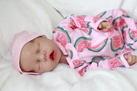 Thumbnail for A baby doll wearing a diaper on its face, creating a whimsical and amusing visual.