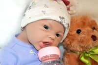 Thumbnail for A baby doll is positioned on a blanket with a teddy bear, symbolizing innocence and the joy of playtime.