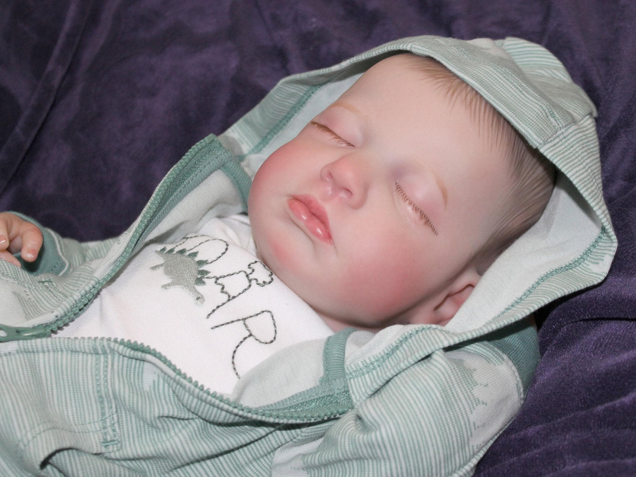 A peaceful baby sleeping soundly, wrapped snugly in a soft blanket.