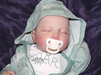 Thumbnail for A peaceful baby sleeping soundly, wrapped snugly in a soft blanket.