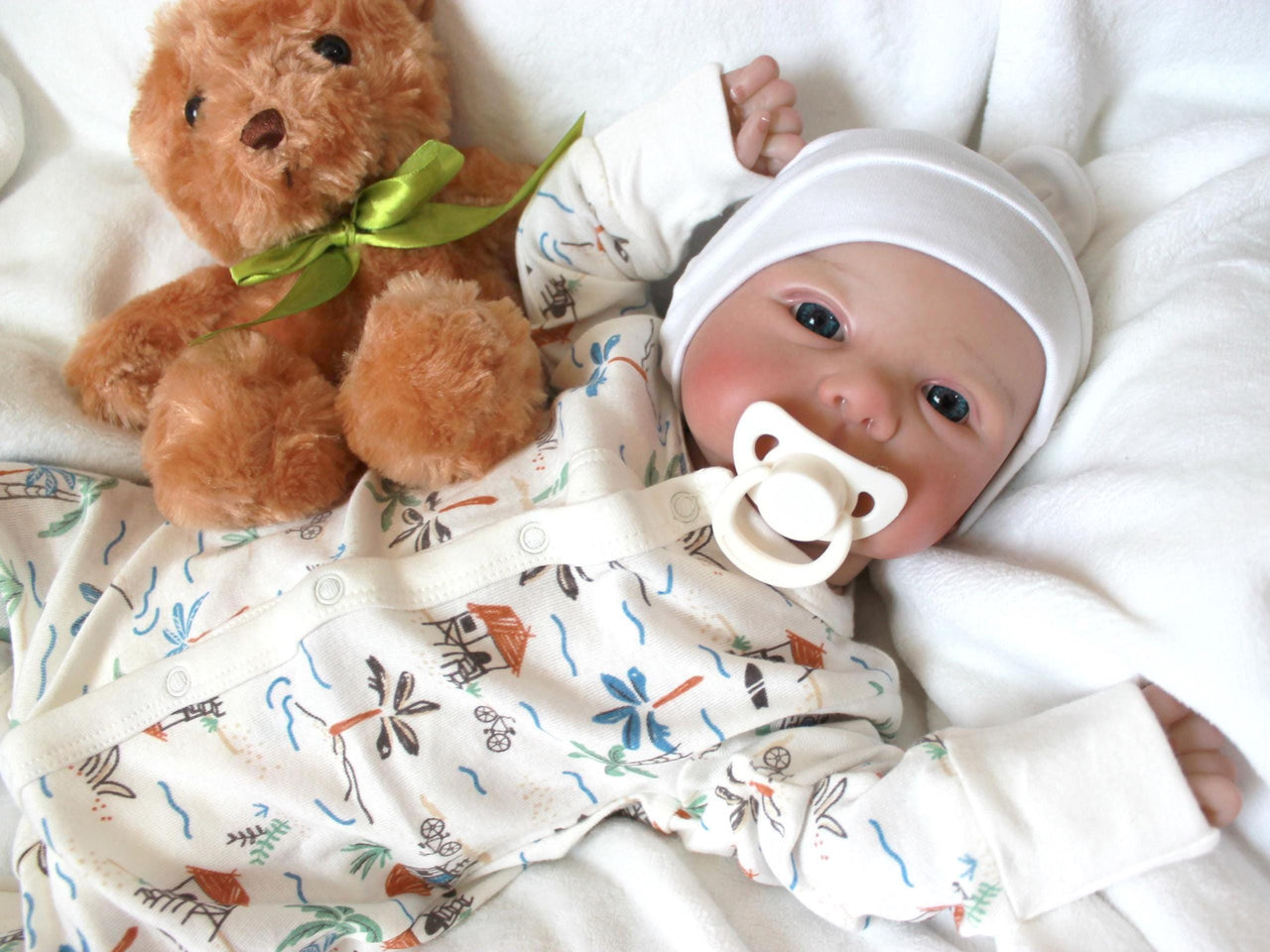 A baby doll lying on a pristine white sheet, emphasizing its adorable appearance and gentle colors.
