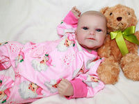 Thumbnail for A baby dressed in pink cuddles a teddy bear, exuding joy and innocence.