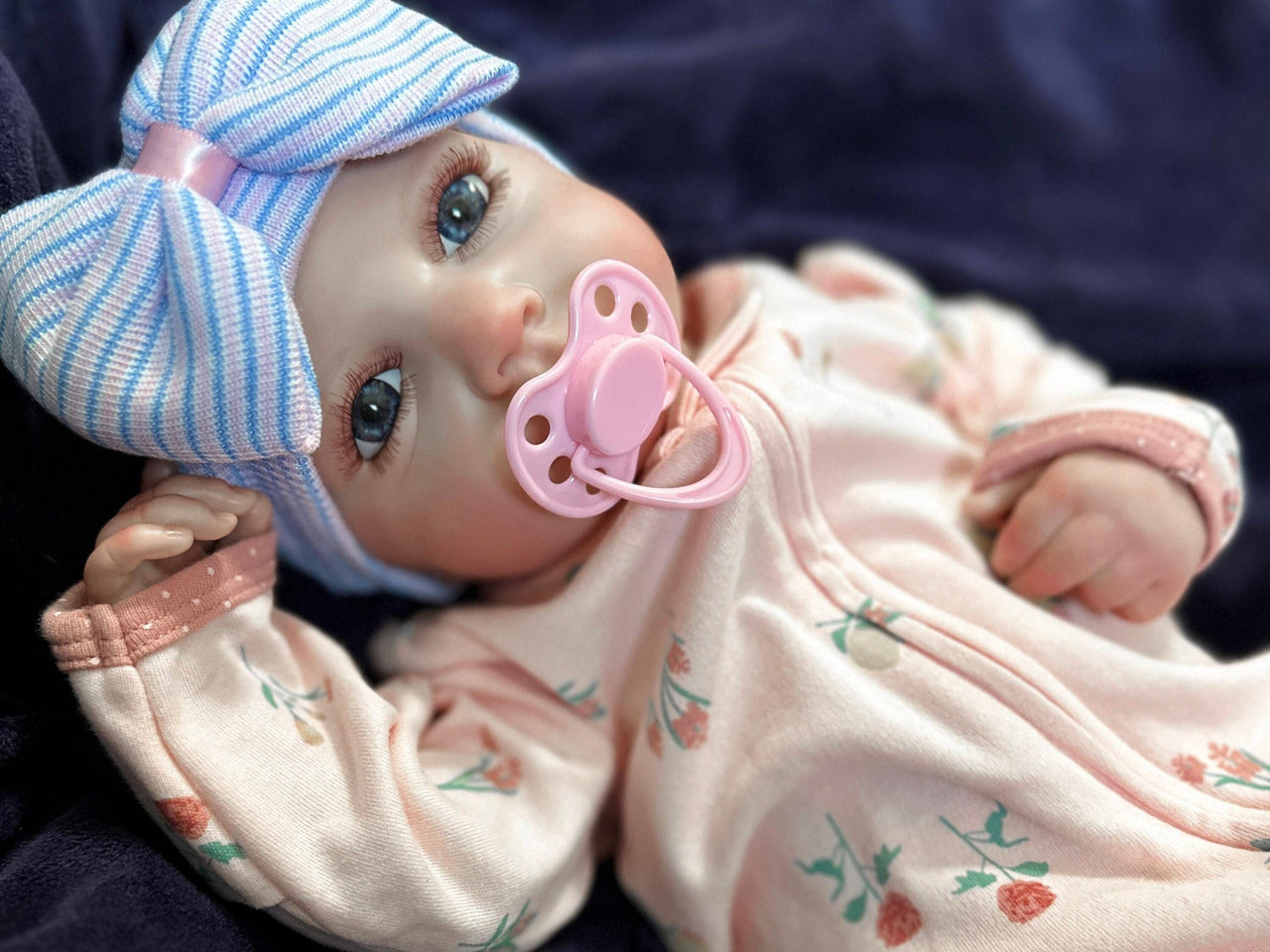Weighted reborn baby doll with blue eyes and soft cloth body, therapy doll designed for comfort, realism, and relaxation