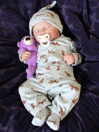Thumbnail for Sleeping reborn baby doll in fox-print pajamas with matching hat, holding a purple teddy bear, lifelike newborn with white pacifier