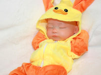 Thumbnail for Sleeping reborn baby doll in yellow and orange duck costume with floppy ears, lifelike 13-inch silicone newborn doll on white blanket