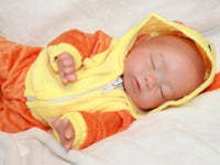 Thumbnail for Sleeping reborn baby doll in yellow and orange duck costume with floppy ears, lifelike 13-inch silicone newborn doll on white blanket