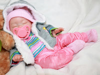 Thumbnail for Sleeping reborn silicone baby doll wearing pink knit hat, striped shirt, and pink pants, lifelike 13-inch newborn doll on white blanket