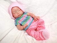 Thumbnail for Realistic full silicone reborn baby doll dressed in colorful striped top with pink pants and hat, handmade preemie newborn doll