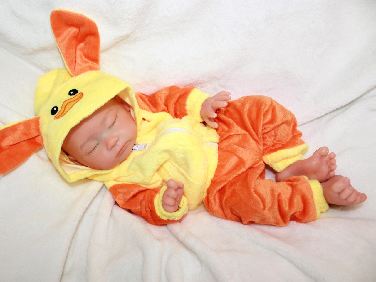 Handmade reborn silicone baby doll, 13-inch lifelike preemie dressed in yellow duck-themed pajamas, realistic collectible newborn doll