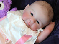 Thumbnail for A baby doll positioned on a bed, symbolizing innocence and the joy of playtime.