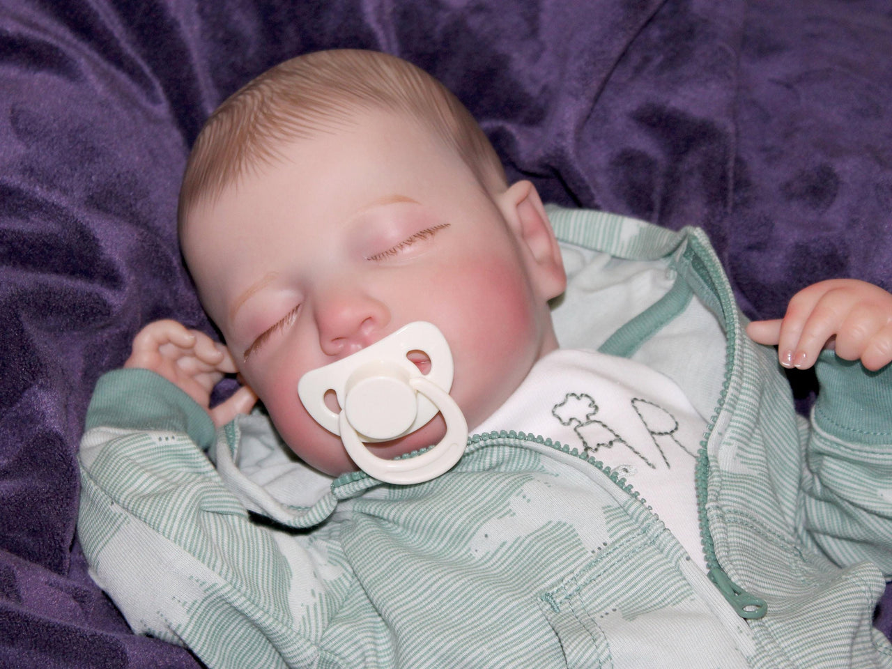 A peaceful baby sleeping soundly, wrapped snugly in a soft blanket.