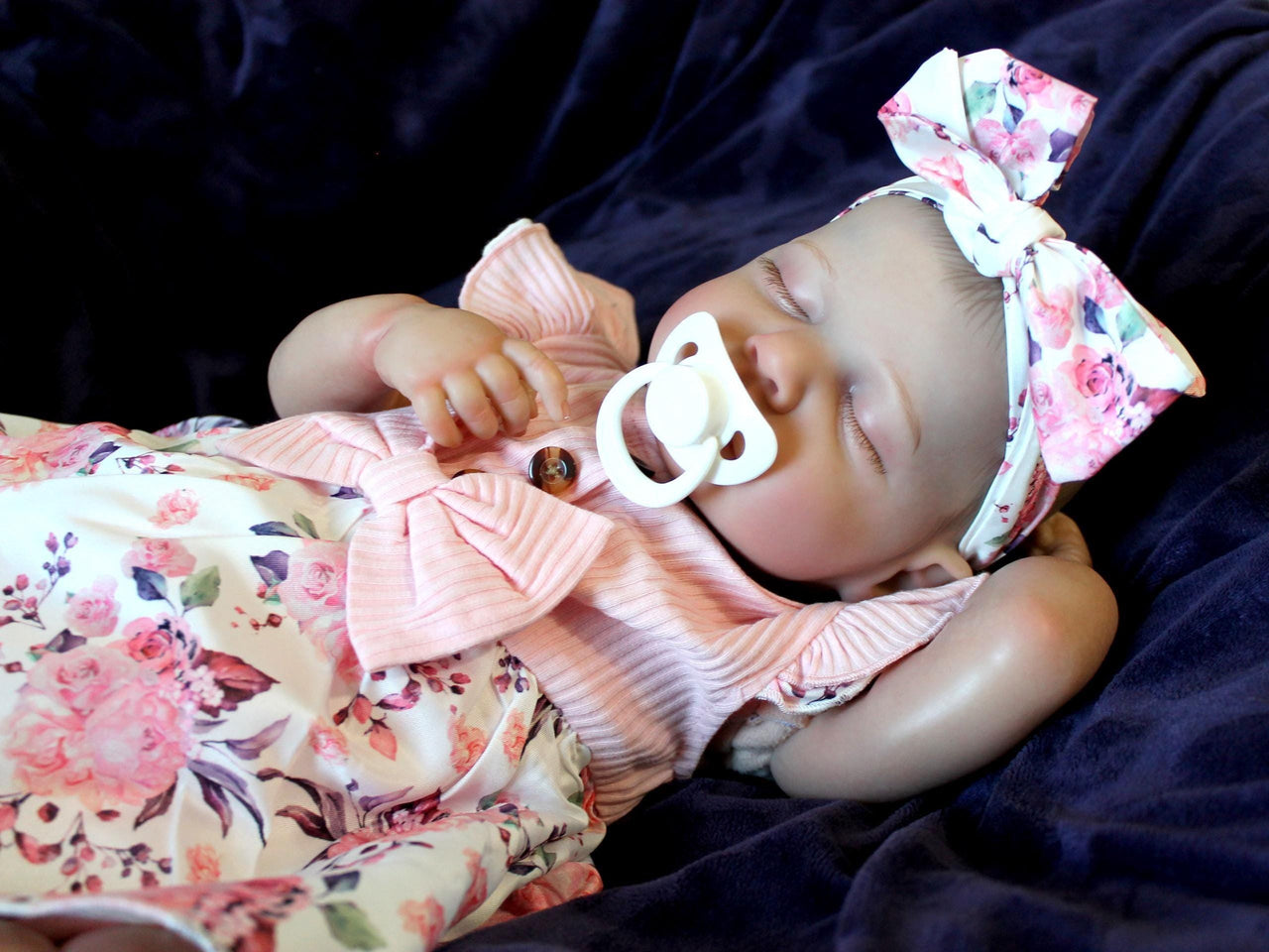 Doll with rotating arms and a rotating head with a cloth body and vinyl limbs. The hair is painted on the head.