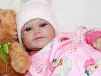 Thumbnail for A baby dressed in pink cuddles a teddy bear, exuding joy and innocence.