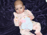 Thumbnail for Realistic reborn baby doll dressed in pink floral pajamas with pacifier, cuddly lifelike doll for kids to play and nurture