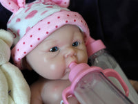 Thumbnail for Realistic reborn baby doll dressed in pink bear-print outfit and matching hat, handmade newborn doll for collectors, play, or therapy