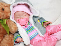 Thumbnail for Realistic full silicone reborn baby doll dressed in colorful striped top with pink pants and hat, handmade preemie newborn doll