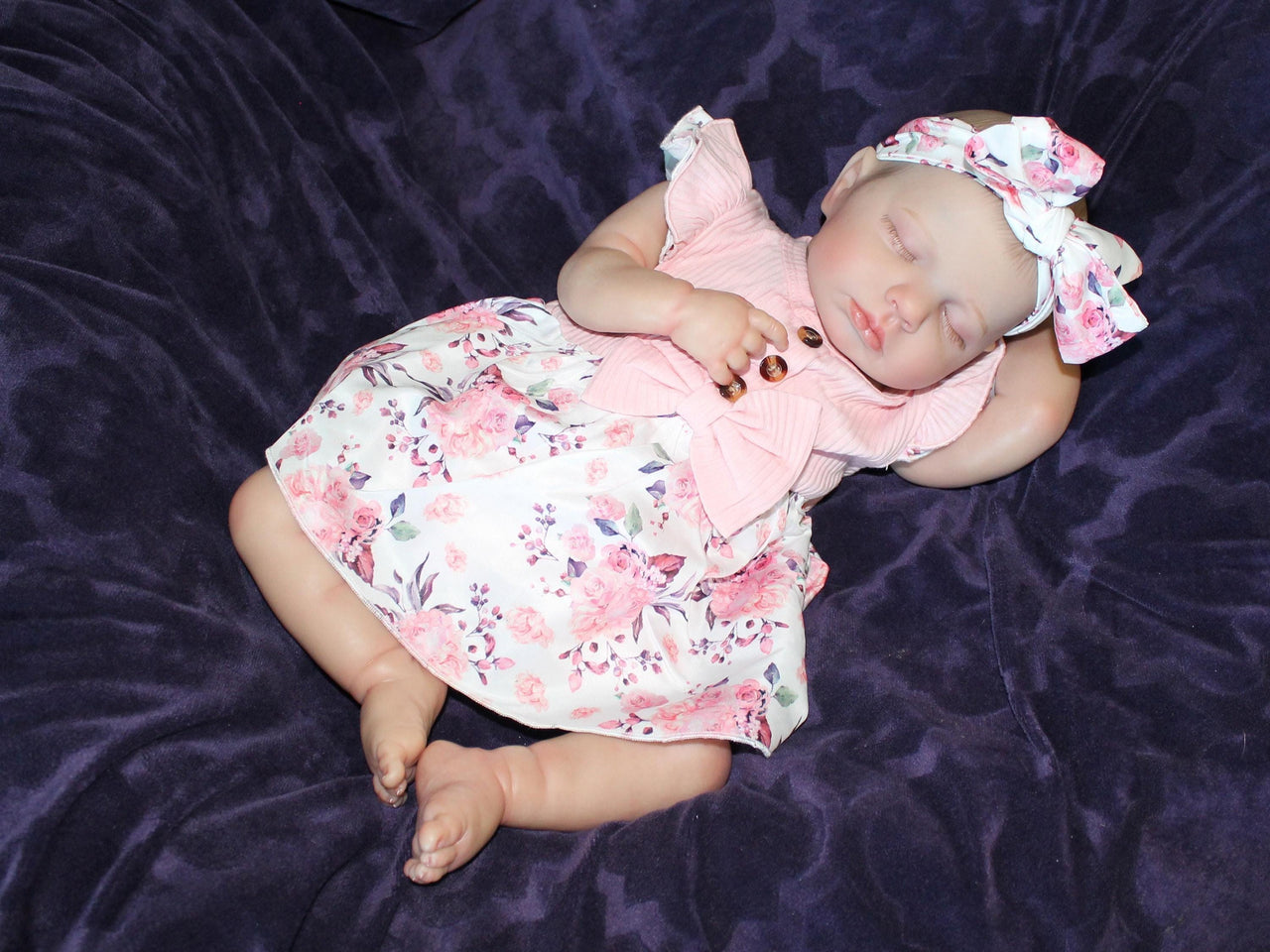 Doll with rotating arms and a rotating head with a cloth body and vinyl limbs. The hair is painted on the head.