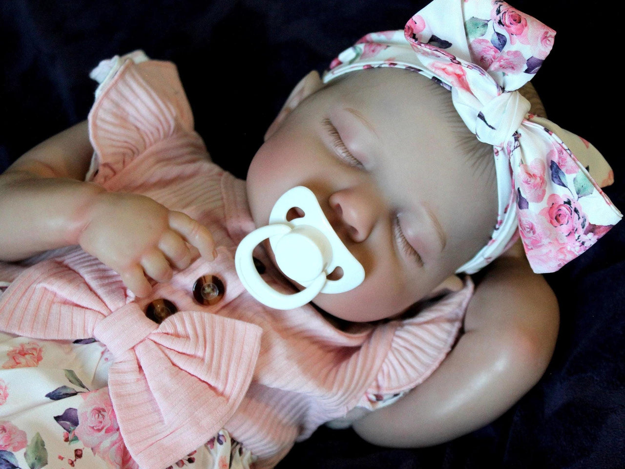 Doll with rotating arms and a rotating head with a cloth body and vinyl limbs. The hair is painted on the head.