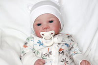 Thumbnail for A baby doll lies on a bed, evoking a sense of childhood comfort and companionship.