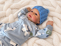 Thumbnail for Realistic reborn baby doll featuring lifelike newborn details, delicate facial features, realistic skin texture, hand-painted details, and beautiful expressive eyes. Photographed resting naturally on a soft, cozy baby blanket to showcase the doll's realistic appearance and craftsmanship.