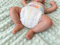 Thumbnail for Realistic reborn baby doll featuring lifelike newborn details, delicate facial features, realistic skin texture, hand-painted details, and beautiful expressive eyes. Photographed resting naturally on a soft, cozy baby blanket to showcase the doll's realistic appearance and craftsmanship.