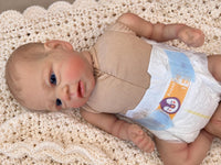 Thumbnail for Realistic reborn baby doll featuring lifelike newborn details, delicate facial features, realistic skin texture, hand-painted details, and beautiful expressive eyes. Photographed resting naturally on a soft, cozy baby blanket to showcase the doll's realistic appearance and craftsmanship.